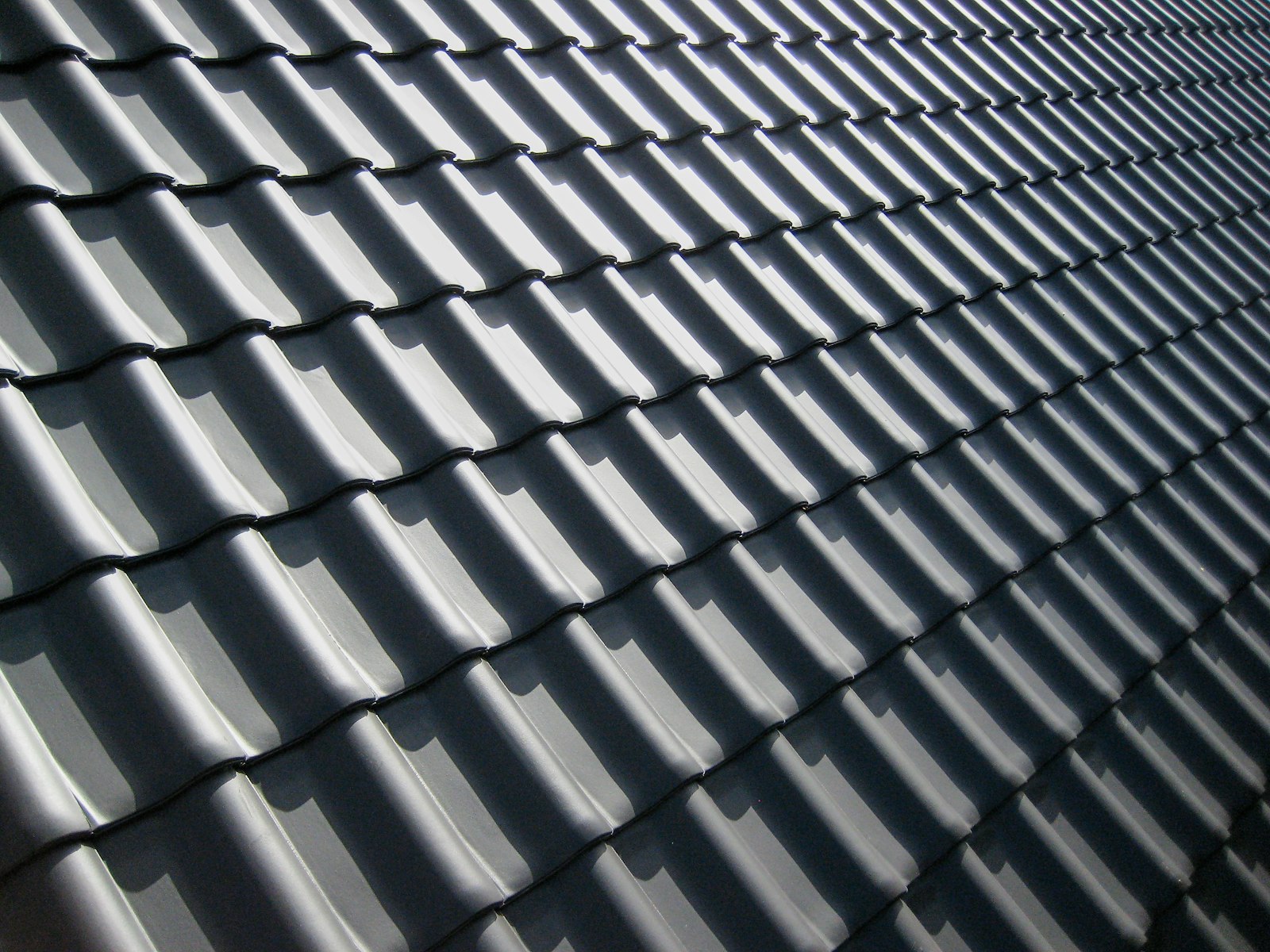 Charcoal tile roof with perfectly even color after a soft wash treatment