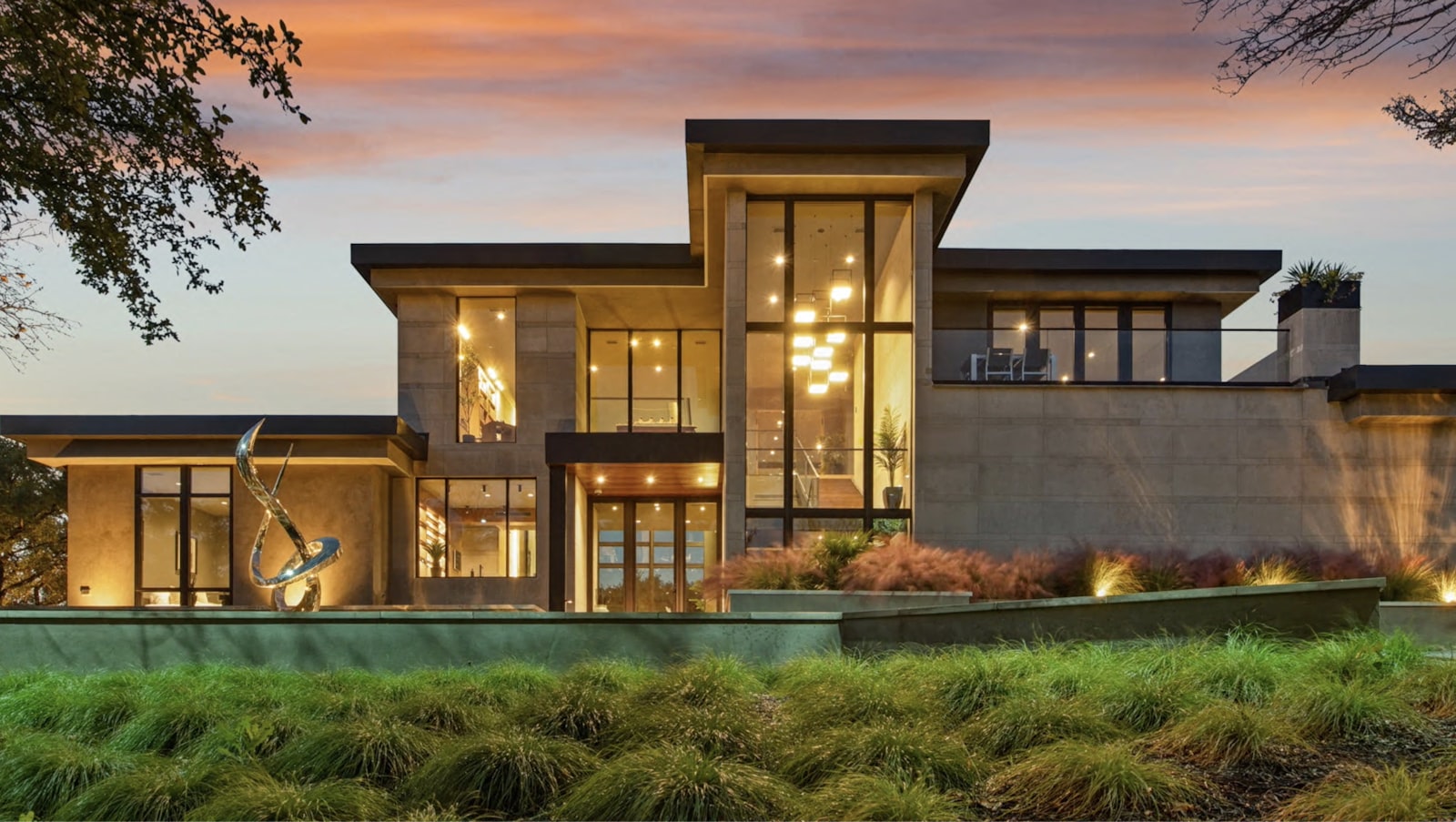 Luxury home glowing at dusk with a spotless exterior