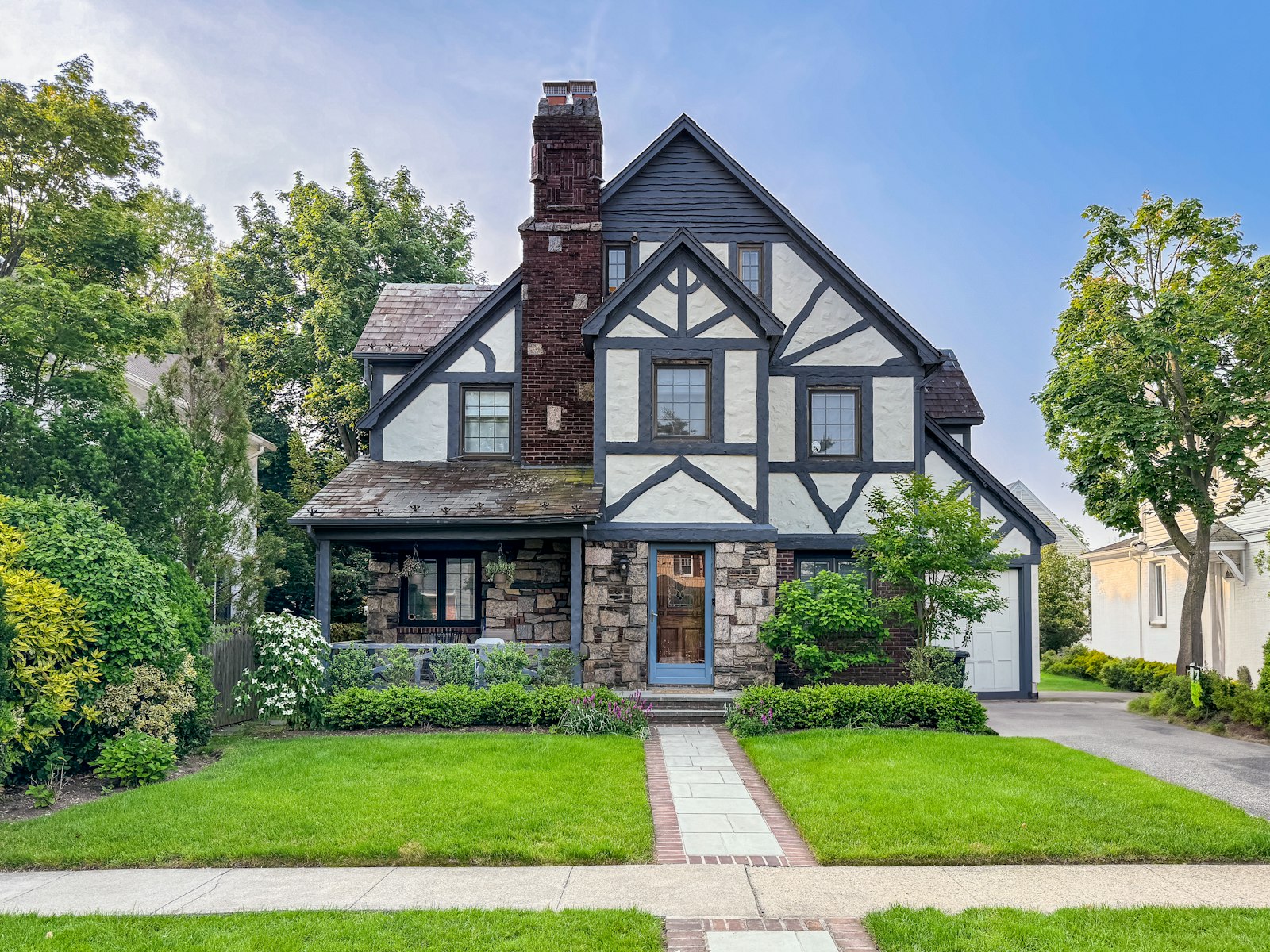 Two story home with crisp trim and a clean stone walkway after a soft wash